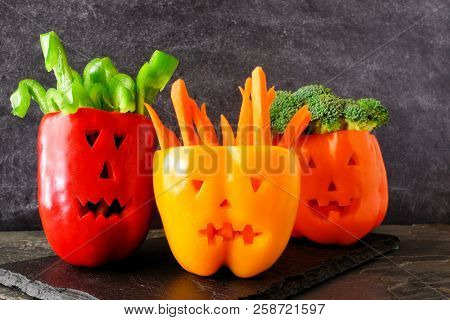 Healthy Halloween Food. Vegetables For Dipping In Jack O Lantern Bell Peppers. Close Up Against A Da