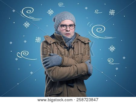 Young hipster frozen boy with doodled snowflakes and windy concept