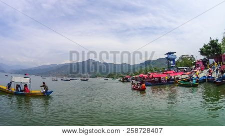 Pokhara, Nepal - April 10, 2018: The People Sitting At Colorful Wooden Boat At Fewa Lake In Pokhara,