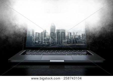 Laptop and construction concept. Mixed media