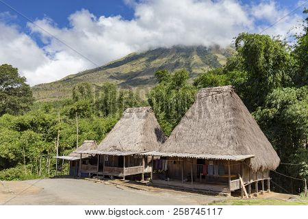 Traditional Houses In The Bena Village With Mount Inerie In The Background On Flores, Indonesia.