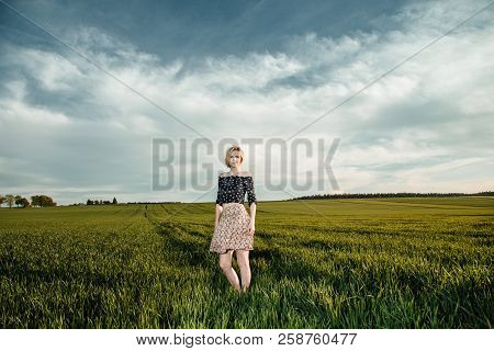 Young Girl In A Green Field. Stylish Girl. Green Grass And Blue Sky. Emotional Woman. Plener. Travel
