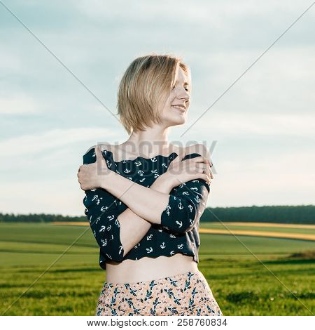 Young Girl In A Green Field. Stylish Girl. Green Grass And Blue Sky. Emotional Woman. Plener. Travel