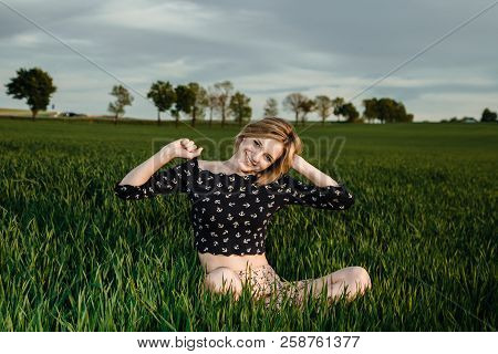 Young Girl In A Green Field. Stylish Girl. Green Grass And Blue Sky. Emotional Woman. Plener. Travel