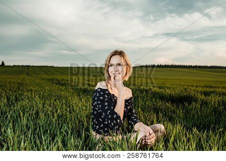 Young Girl In A Green Field. Stylish Girl. Green Grass And Blue Sky. Emotional Woman. Plener. Travel