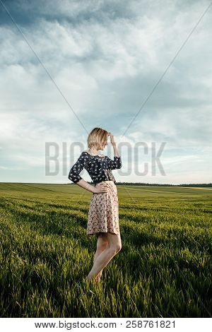 Young Girl In A Green Field. Stylish Girl. Green Grass And Blue Sky. Emotional Woman. Plener. Travel