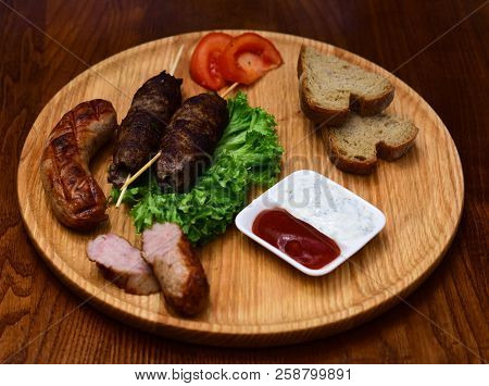 Hot Meat On Stick Served On Wooden Board. Meat Dish Cooked On Grill. The Magic Grill.