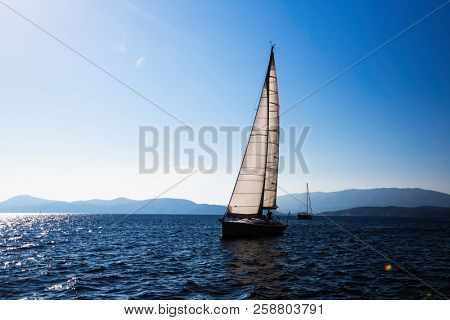 Sailing ship luxury yacht with white sails in the Sea.