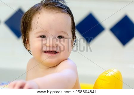 Baby Boy Taking A Bath In A Big Bath Tub