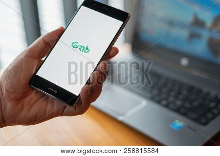 Chiang Mai, Thailand - July 13,2018: Man Hands Holding Huawei With Grab Apps On Screen. Grab Is Smar
