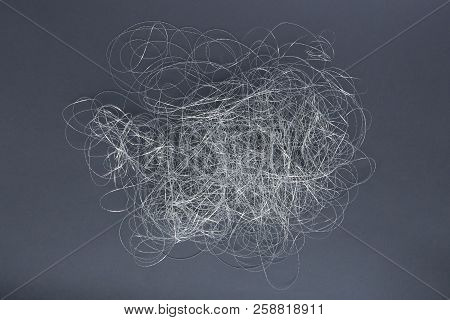 Silver Thread Pile Like Cloud. Pile Of Silver Thread On Grey Background.