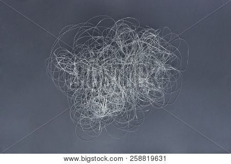 Silver Thread Pile Like Cloud. Pile Of Silver Thread On Grey Background.