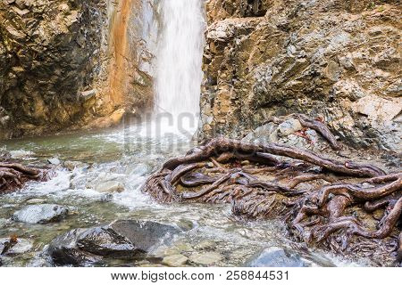 Autumn Waterfall With Rocks And Leaves In Troodos Mountains In Cyprus
