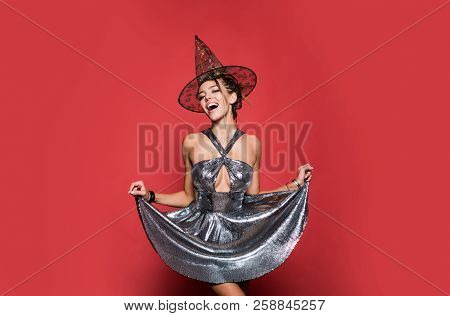 Gelightful Blonde Lady Dressed In A Fashionable Dress On Red Background. Halloween Dresses And Witch