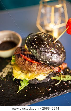 Jucy Burger With French Fries And Soia Sos On Restaurant Table