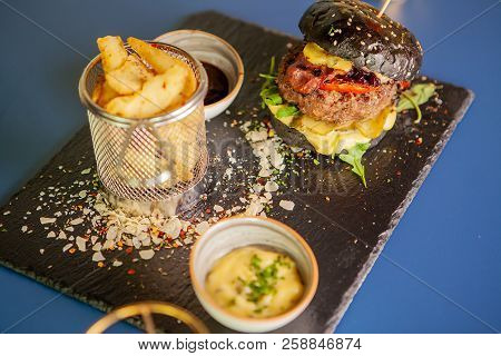 Jucy Burger With French Fries And Soia Sos On Restaurant Table