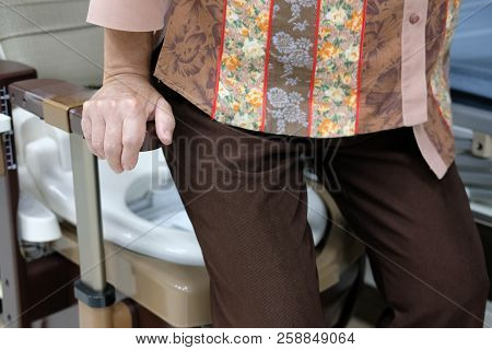 Old Woman Use Portable Mobile Plastic Toilet Near  Patient Bed