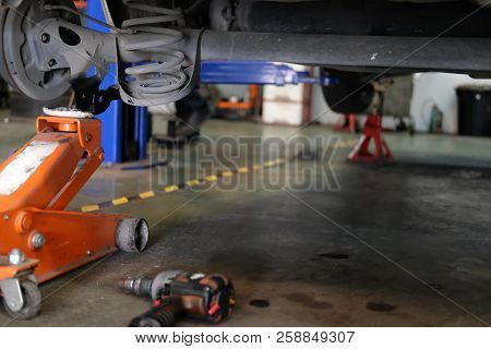Car Lift Up For Shock Absorber & Spring Replacement In Auto Repair Garage