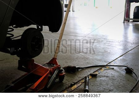 Brake Disc & Wheel Hub Axle Heck In Auto Service. Car Lift Up For Tyre Replacement In Garage.