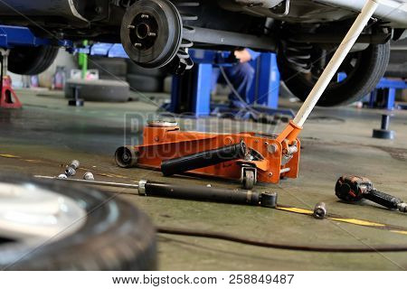 Brake Disc & Wheel Hub Axle Heck In Auto Service. Car Lift Up For Tyre Replacement In Garage.