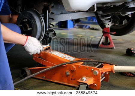 Mechanic Replace Shock Absorber & Spring In Auto Service Repair Garage