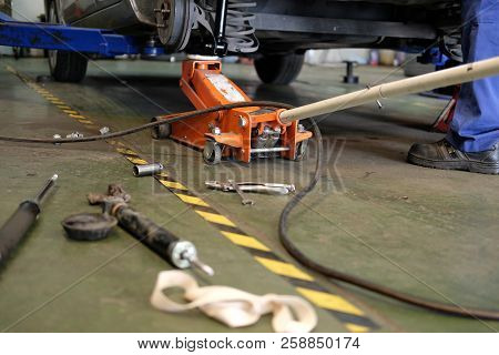 Car Lift Up For Shock Absorber & Spring Replacement In Auto Repair Garage