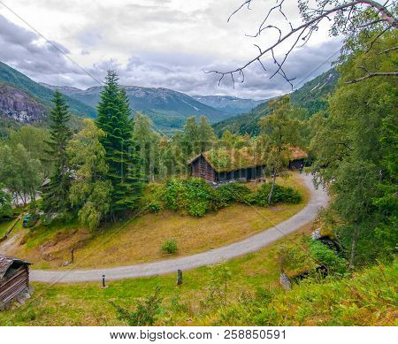 Typical Norwegian Cloudy Summer Day In Stalheim, Norway. Tradational Wooden Houses With Moss On Roof