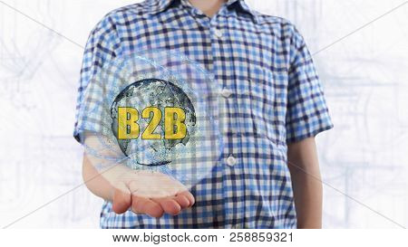 Young Man Shows A Hologram Of The Planet Earth And Text B2b