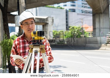 Civil Engineer Land Survey With Tacheometer Or Theodolite Equipment. Worker Checking Construction Si