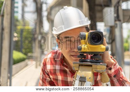 Civil Engineer Land Survey With Tacheometer Or Theodolite Equipment. Worker Checking Construction Si