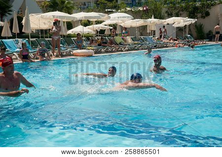 Turkler, Turkey - July 30, 2018: A Group Of People Playing In The Pool In A Water Polo Ball. Athlete