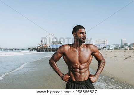 Fit man posing at the beach