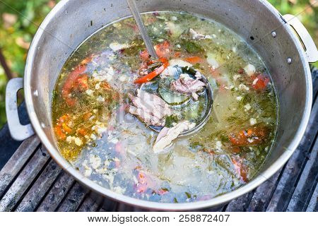 Top View Of Pot With Asian Shurpa (soup From Meat And Large-sliced Vegetables) Outdoors