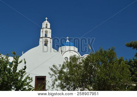 Bell Tower And Main Facade Of The Beautiful Church Of Pyrgos Kallistis On The Island Of Santorini. T