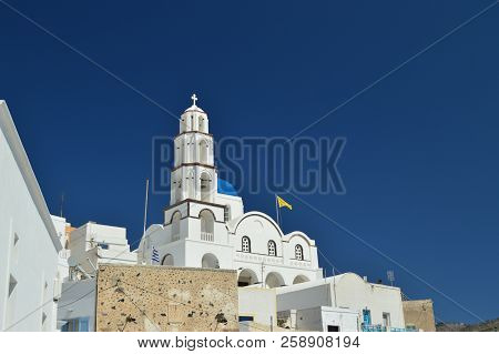 Bell Tower And Main Facade Of The Beautiful Church Of Pyrgos Kallistis On The Island Of Santorini. T