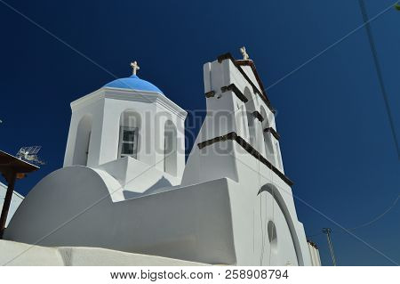 Bell Tower And Main Facade Of The Beautiful Church Of Pyrgos Kallistis On The Island Of Santorini. T