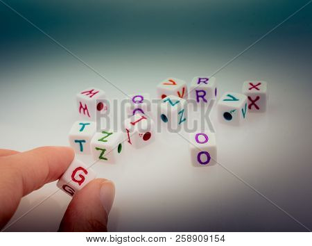 Colorful Alphabet Letter Cubes In Handon A White Background