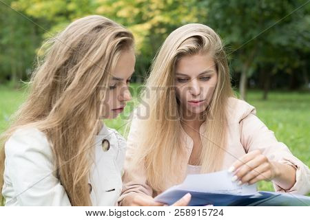 Portrait Of A Beautiful Happy Cheerful Cute Young Ladies Girls Students Sitti In Park