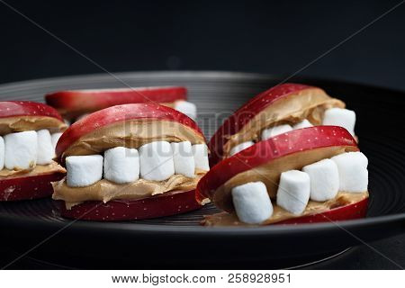 Fun Food For Kids. Halloween Apple Mouths Filled With Peanut Butter With Mini Marshmallows For Teeth