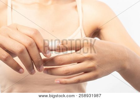 Woman Injured Finger And Using Bandage.