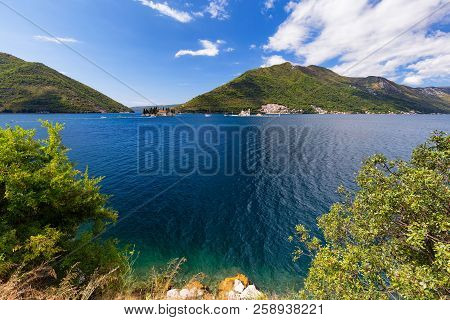Crystal Clear Water Around The Our Lady Of The Rock And The Sveti Dordje Churches On Neighboring Isl