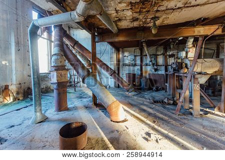 Abandoned Flour Milling Factory. Rusty Broken Pipeline And Mechanisms