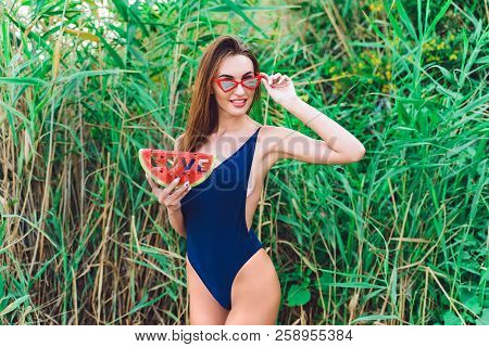 Beautiful Young Female In Swimsuit And Red Sunglassses Hold Slice Of Watermelon With Inscription Lov