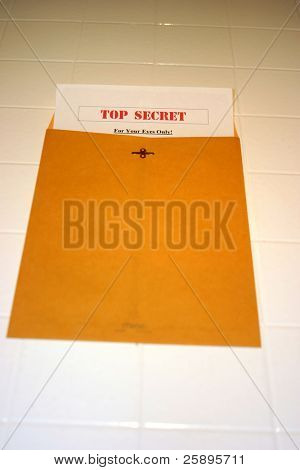 A Top Secret (for your eyes only) document peeks out of a manila envelope