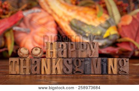 Happy Thanksgiving Text Wtitten With Wooden Block Letters On A Colorful Autumn Background