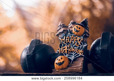 Halloween Festival Close Up Of Halloween Head Pumpkins Doll And The Black Iron Dumbbell. Fitness, He