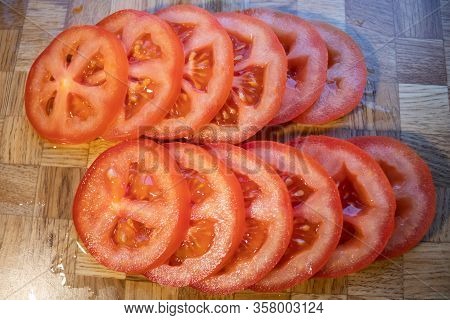 Cutted Red Tomato Slices On Chopping Board