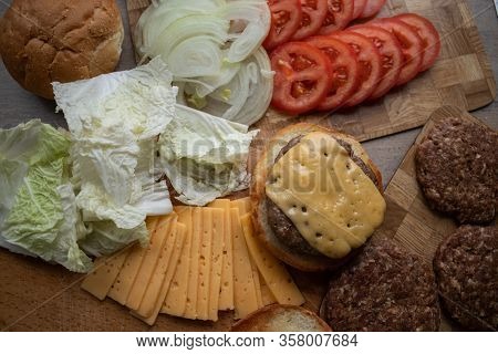 Classic Gamburger With Tomato On Wooden Board