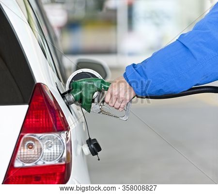 Woman’s Hand Pumping Gasoline