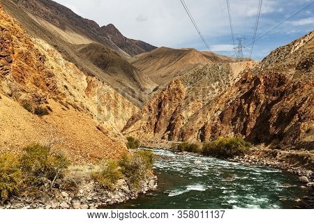 Mountain River And Power Lines. Kokemeren River In Naryn Region Of Kyrgyzstan.